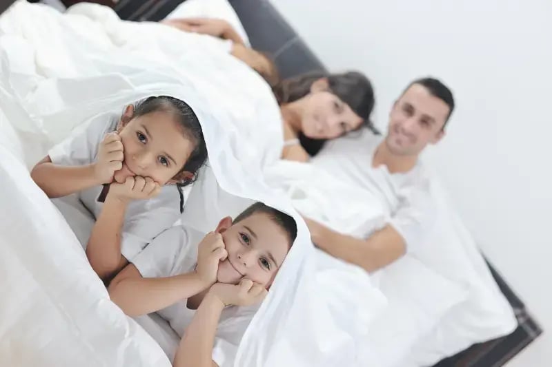 vecteezy_happy-young-family-in-their-bedroom_10797755
