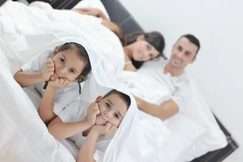 vecteezy_happy-young-family-in-their-bedroom_10797755